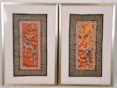 A pair of Japanese embroided silks of birds and flowers, set in frames and glazed. 45cm x 23cm.