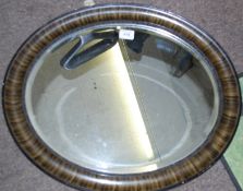 A retro oval mirror with bevelled glass and decorative border. 69cms x 50cms