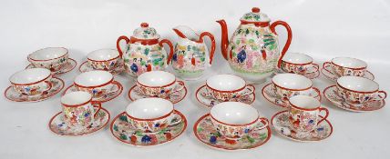 A mid 20th century Japanese Satsuma translucent ware tea service to include the teapot, cups,