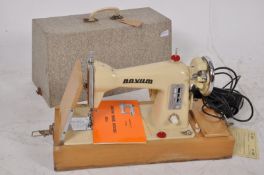 An early singer sewing machine having been converted to electric and recased in the 1960`s.