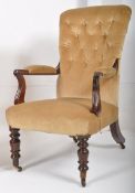 A Victorian mahogany button back low armchair. The mahogany turned legs with original castors
