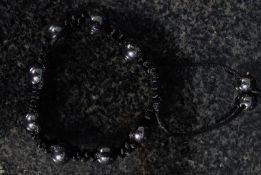 A ladies Shambala bracelet with black bead decoration