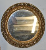 A large 20th century Regency revival circular gilt porthole mirror with a fret surround. Back