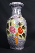 A 20th century hand painted / decorated vase with foliate decoration