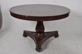 A Regency 19th century mahogany tilt top dining / breakfast table. Quatrefoil base with shaped
