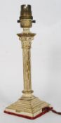 A 1920`s brass table lamp of neo classical style with reeded columns on brass plinth base, together