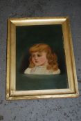 An oil on canvas of a young girl, signed EW and framed. 32cm x 22cm.