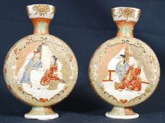 A pair of Japanese Satsuma oriental hand painted moon flasks. Raised on circular bases, the bodies