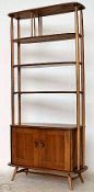 An original 1970`s Ercol two tone room divider / bookcase. The turned light beech wood supports