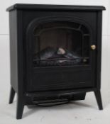 An electric fire in the style of a cast iron woodburner complete with faux coal inset