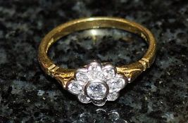 An 18k diamond daisy ring approx 20pts. Size Q