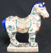 A decorative painted Chinese oriental horse. 30cm tall.