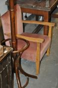A 1930`s oak Arts & Crafts revival upholstered fireside armchair. Raised on squared supports with