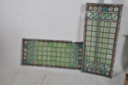 A pair of large 19th century eclesiastical lead glass panels of square and concentric circle