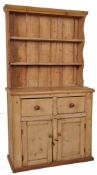 A 19th century Victorian pine country dresser. Plinth base with cupboard under 2 short drawers