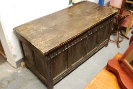 A Georgian 18th century elm country coffer / chest raised on style legs with impressed foliate
