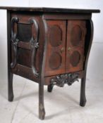 A Victorian oak gothic arts and crafts ecclesiastical side cabinet raised on shaped legs with