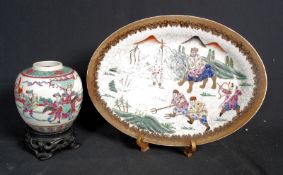 A decorative Chinese oriental platter with crackle glaze decoration and scenese of warriors