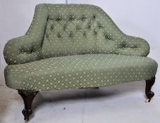 A Victorian mahogany upholstered love seat / sofa settee. The reeded cabriole legs with hoof feet