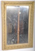 An Edwardian gilt painted wall mirror. The wooden frame being gilt painted having later mirror set