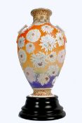 A pair of 19th century Japanese decorative Satsuma orange blush urns / vases, one raised on an