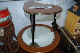 A retro mirror top occasional table together with another.