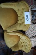 A pair of Victorian style yellow velour tub armchairs having button backed upholstery and turned
