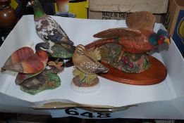 A ceramic pheasant on plinth along with snipe and goose together with a pigeon figurine from the