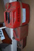 A vintage large red jerry can together with 2 others