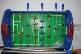 A foosball table with a pro shot golf game.