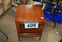 A Georgian style yew wood occasional table raised on turned legs with castors having single drawer