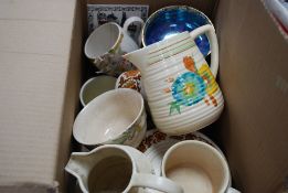 A Clarice Cliff jug along with a part Midwinter tea service and other items.