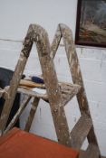 A vintage step ladder wooden along with pasting table.