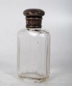 A solid silver topped cut glass scent bottle hallmarked for 1885 being 10cms tall 91g