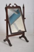 An Edwardian mahogany toilet swing mirror. The splayed legs having gilt decorated border to the
