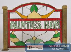 A vintage stained glass pub / cafe section divider for `Auntie`s Bar` Set in brass surround with