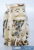 A decorative carved bone oriental figure with Chinese decoration