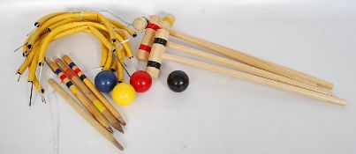 A Croquet game set with hammers and balls.