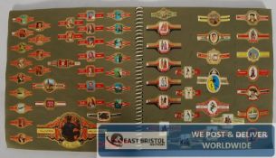 A scrap book of vintage cigar bands, including many novelty ones, tv and film related,
