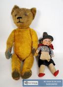 A large vintage straw filled mohair childrens teddy bear 55cm tall.