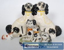 2 Staffordshire dogs, along with dogs on a plinth and one other.