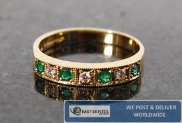 A good ladies emerald and diamond  18ct gold half eternity ring. The alternating stones being