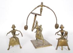 A trio of bronze West African figurines to include a balanced figurine and 2 others
