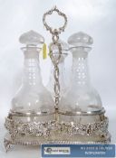 A large silver plated three bottle tantalus, with cut glass decanters and stopped on a decorative