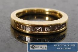 A ladies gold and diamond half eternity ring. The channel set diamonds approximately 50 pts mounted