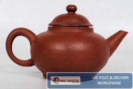 A Chinese 20th century small Yi Xing tea pot bearing markings to the base, complete with lid
