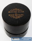 A 20th century cased etched medicine glass, along with a minim measure, complete in their original