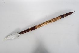 An African spear being double ended. Covered with hide and snakeskin being finished with other