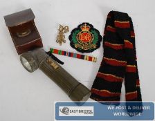 Items relating to a member of the Royal Engineers  in World War 2, to include a GR cap badge, lapel
