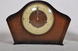 A 1930`s Art Deco oak cased dome top mantle Westminster chime striking clock. The decorative face